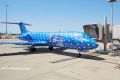 An Alliance Airlines Fokker 70 was wrapped in Christmas paper in a Powerball promotion at Brisbane Airport on Wednesday, ...