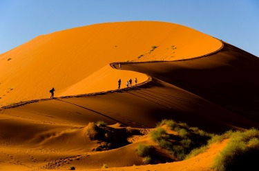 Tourists climbing Sossusvlei dune, Naukluft National Park, Namibia.