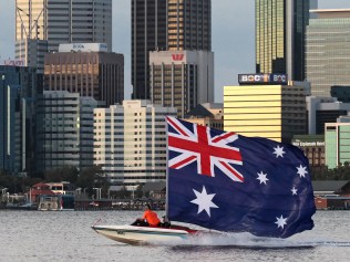 A boat flies an Australian flag along the Swan River in front of the city. Australia Day on the South Perth Foreshore. 26 JANUARY 2016. Picture: Danella Bevis The West Australian