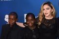 Madonna with son David Banda and daughter Mercy James and Sean Penn at a Haiti gala last year. 