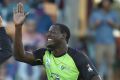 Settling in: Carlos Brathwaite high-fives new teammate Chris Green after taking a wicket.