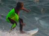 Boy surfs over shark’s gaping jaws