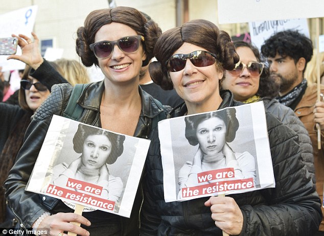 Spirit lives on: Over the weekend, many of those who participated in the Women's March carried signs with Carrie Fisher or her Stars Wars character Princess Leia (LA protesters above) 