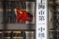 A Chinese flag flies outside the No. 1 People's Intermediate Court in Shanghai. The former Chinalco boss has been jailed ...