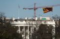 Greenpeace protesters unfurl a banner that reads "Resist" at a site near the White House.