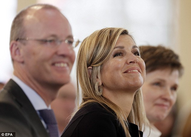 The Dutch royal pted for businesslike attire as she opened the conference in Wiesbaden, Germany, but added a feminine touch with diamond hoop earrings and jewellery