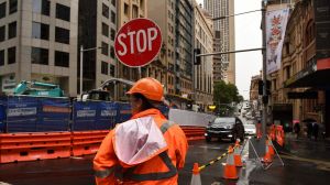 Traffic is condensed to one lane as it weaves past construction of the light rail at the intersection of George and ...