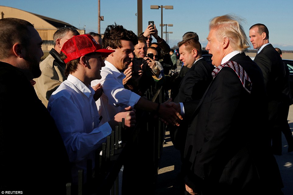 One greeter wore a 'Make America Great Again' to meet Mr Trump on Thursday 