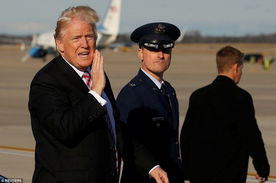 U.S. President Donald Trump shouts to reporters 'windy!' as he arrives aboard Air Force One at Joint Base Andrews, Maryland, U.S. January 26, 2017