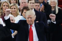 President Donald Trump pumps his fist after delivering his inaugural address