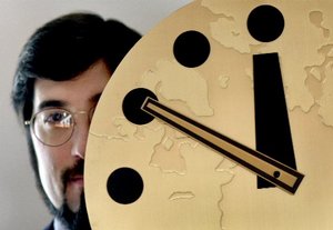  Stephen Schwartz, publisher of the Bulletin of the Atomic Scientists, holds the famous Doomsday Clock, which symbolizes the threat of world nuclear holocaust, Friday, Nov. 2, 2001, at the University of Chicago. After three years of immobility, the board 