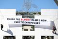 Some protesters unfurled a banner on the Parliament House building.