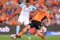 Luke DeVere of the Roar tackles Melbourne City's Tim Cahill at Suncorp Stadium.