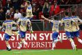 SYDNEY, AUSTRALIA - OCTOBER 23: Andrew Hoole of the Jets celebrates with team mates after scoring the final goal during ...