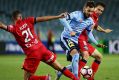 Sliding tackle: Milos Ninkovic is challenged by Tarek Elrich and Isaias at Allianz Stadium.