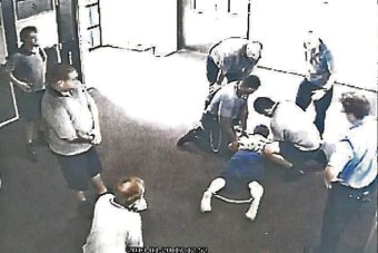 The boy, 17, is placed in handcuffs and ankle cuffs in Cleveland Youth Detention Centre.