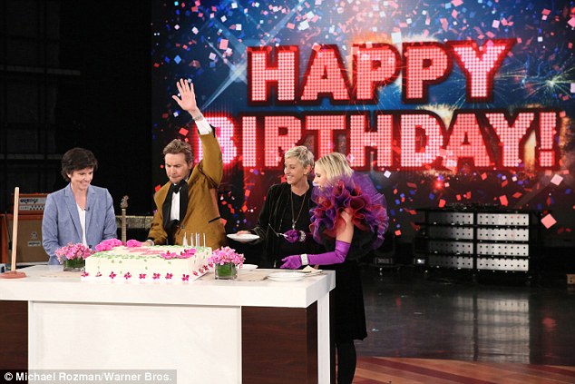 Birthday girl: Ellen grinned as she grabbed a plate