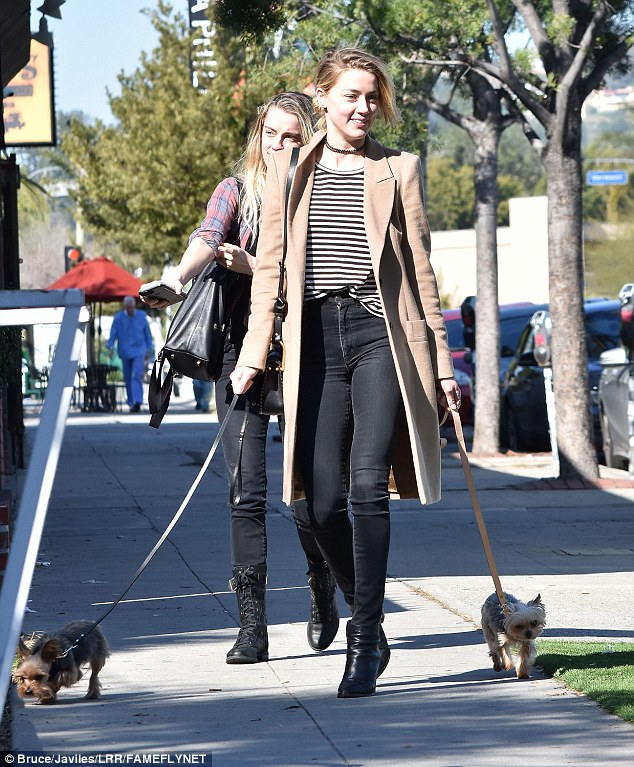 Ready for anything: Prepared in case the weather turned cold, she had on a knee-length, camel-colored overcoat