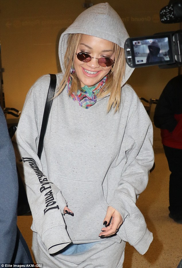 Looking good: Rita grinned as she left the Los Angeles airport on Thursday