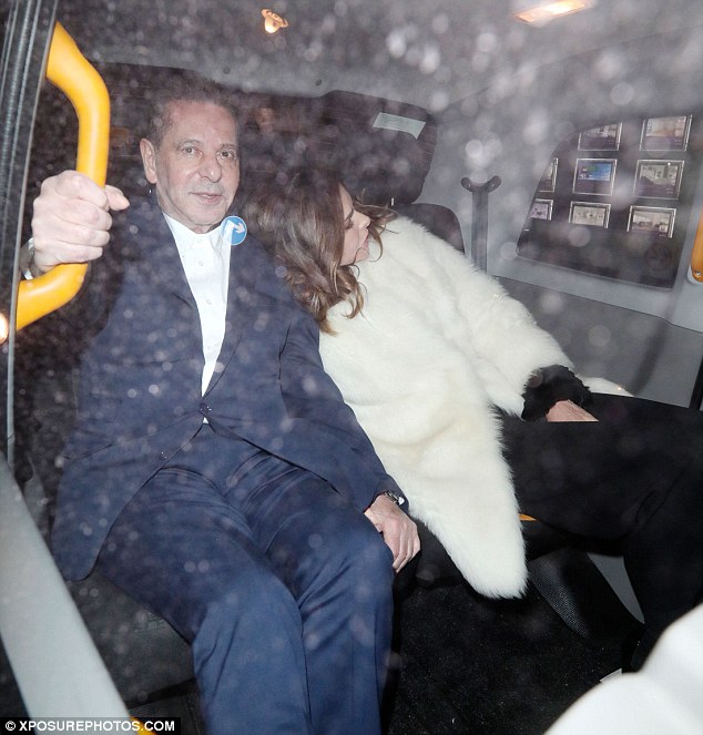 Loved up: Trinny rested her head on the businessman's shoulder as they headed off in a cab