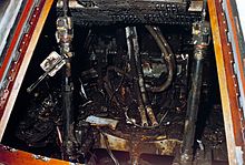 The inside of a small spaceship, charred and apparently destroyed.