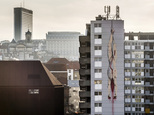 A mural of a gutted body hanging upside down with blood seeping out, is painted on an apartment building in Brussels on Thursday, Jan. 26, 2017. Depicting details from Caravaggio and Dutch Master paintings, an anonymous street artist is the talk of the town and again asks that age-old question about art: how far can it go before it outrages just too much. (AP Photo/Geert Vanden Wijngaert)