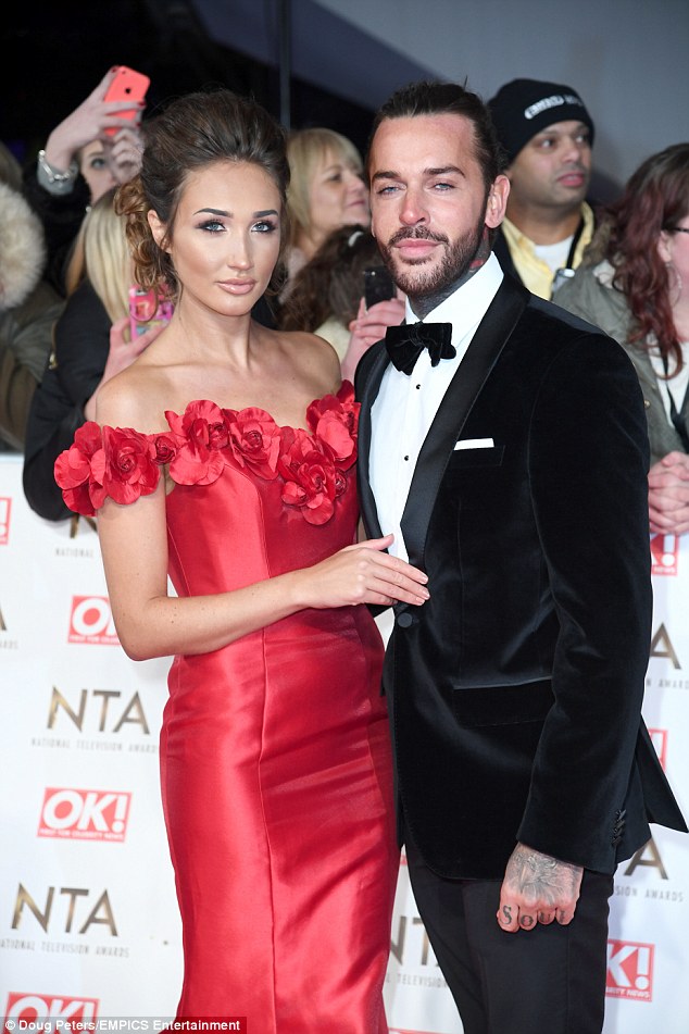 Fuming: Megan graced the red carpet earlier in the evening on the arm of her tuxedo-clad boyfriend, where she looked sensational in a stunning red two-piece