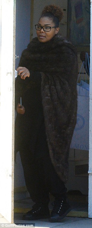 Fur-ry warm! The Rhythm Nation singer bundled up in a long brown hooded mink and dark clothing for her afternoon outing