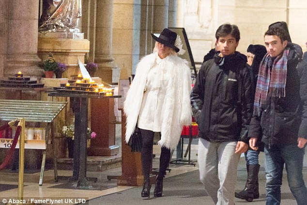 Solemn: She looked solemn as she quietly made her way around the interior of the church 