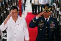 Philippine President Rodrigo Duterte salutes the honour guard.