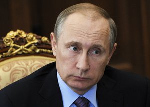 FILE - In this Tuesday, July 26, 2016 file photo, Russian President Vladimir Putin listens during a meeting in the Kremlin, in Moscow, Russia. Donald Trump just keeps giving Russian President Vladimir Putin more reasons to hope he wins the U.S. election, while raising serious questions about the Republican candidate’s intentions toward the Kremlin.