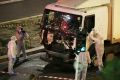 Authorities investigate the truck that drove through Bastille Day crowds in Nice late on Thursday night.