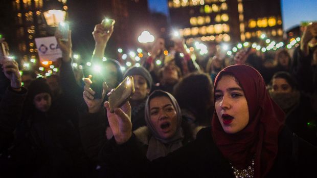 Muslim women shout slogans during a rally against President Donald Trump's order cracking down on immigrants living in ...