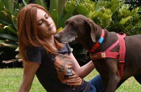 Alex Thomas from PetSure, Sydney, with dog Teddy wearing a FitBark. 