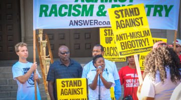 People holding signs protest against Trump. “2016.09.12 DC People and Places 07832” by Ted Eytan is licensed under CC BY-SA 2.0.