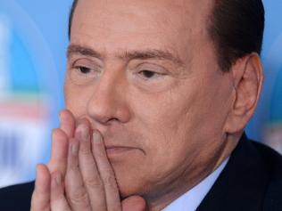 (FILES) This file photo taken on February 01, 2013 shows former Italian Prime Minister Silvio Berlusconi reacting during a press conference following a meeting of the Popolo della Liberta (PDL) with the European's People's party (PPE) in Rome. Prosecutors in Milan asked on December 15, 2016 for Silvio Berlusconi to be sent for trial for allegedly buying the silence of witnesses to his notorious 'bunga bunga' sex parties. A judge is expected to rule in January 2017 on whether the 80-year-old tycoon and former prime minister should join 23 others in court on various charges of perverting the course of justice in relation to the case. Prosecutors suspect Berlusconi bought the silence of young women who attended his parties and others now facing trial by showering them with millions of euros worth of gifts in the form of cash, jewellery, holidays and even properties. / AFP PHOTO / FILIPPO MONTEFORTE