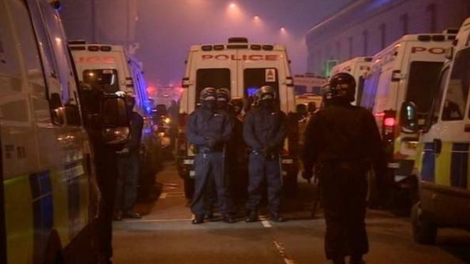 'Stormtroopers' prepare to enter as smoke billows from the fires in the prison.