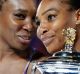 United States' Serena Williams, right, holds her trophy after defeating her sister Venus, left, during the women's ...