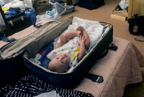 Baby in Hotel Suitcase Crib