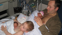 The dad and son each held one of the twins skin-to-skin. 