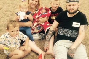 Amber Hughes with her husband Daniel and children Kayden, Harvey, Jessica and Olly. 