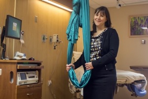 Midwife Carrie Neerland with the birthing sling at The Birthplace at University of Minnesota Masonic Children's Hospital.