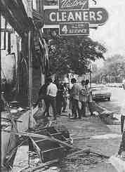 Fifth Estate co-editors Ovshinsky & Werbe interview looters as they window-shop at a cleaners at the corner of Trumbull and Forest. Photo by C.T. Walker.