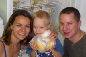 Amy Anderson with her son and husband with some of her donated breast milk.