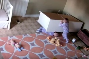 A toddler has rescued his twin brother from underneath a fallen dresser.
