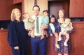 The new parents of four and the judge who made the adoptions official.