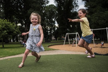 Sisters Ruby and Evie play in the Carlton Gardens.