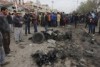 Citizens inspect the scene after a car bomb explosion at a crowded outdoor market in the Iraqi capital.