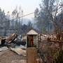 A religious figurine is seen in front of a burnt construction site as the worst wildfires in Chile's modern history ravage wide swaths of the country's central-south regions, in Santa Olga, Chile January 26, 2017. REUTERS/Pablo Sanhueza EDITORIAL USE ONLY. NO RESALES. NO ARCHIVE.