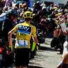 Great Britain's Christopher Froome (C), wearing the overall leader's yellow jersey, runs to get a replacement bike following a fall during the 178 km twelvelth stage of the 103rd edition of the Tour de France cycling race on July 14, 2016 between Montpellier and Chalet-Reynard. / AFP PHOTO / JEFF PACHOUDJEFF PACHOUD/AFP/Getty Images